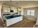 Modern kitchen featuring white cabinets, stainless steel appliances, and a large island with a sink at 40 Commons Cir, Clayton, NC 27520