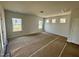 Spacious living room with plenty of natural light from multiple windows, ready for personalization at 40 Commons Cir, Clayton, NC 27520