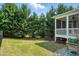 The backyard features lush greenery, a garden, and a screened porch at 409 Kilcornac Ct, Fuquay Varina, NC 27526