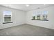 A bright bedroom with multiple windows and neutral colored carpet at 409 Kilcornac Ct, Fuquay Varina, NC 27526