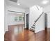 Inviting entryway with hardwood floors, staircase, and a view into the living area with ample natural light at 409 Kilcornac Ct, Fuquay Varina, NC 27526
