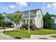Well-manicured lawn surrounding this two-story home with light siding, a garage, and a cozy front porch at 409 Kilcornac Ct, Fuquay Varina, NC 27526