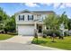 Charming two-story home with a well-maintained lawn, attached garage, and welcoming front porch at 409 Kilcornac Ct, Fuquay Varina, NC 27526