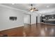 Open-concept living area with hardwood floors and seamless flow into the kitchen and dining spaces at 409 Kilcornac Ct, Fuquay Varina, NC 27526