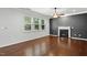 Bright living room featuring hardwood floors, a fireplace, and large windows providing ample natural light at 409 Kilcornac Ct, Fuquay Varina, NC 27526