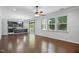 Spacious living room with hardwood floors, seamlessly connected to the kitchen and offering natural light at 409 Kilcornac Ct, Fuquay Varina, NC 27526
