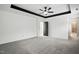 Spacious main bedroom features plush neutral carpeting and doorway leading to the ensuite bathroom at 409 Kilcornac Ct, Fuquay Varina, NC 27526