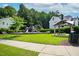 Community playground with picnic benches surrounded by lush trees and grassy areas at 409 Kilcornac Ct, Fuquay Varina, NC 27526