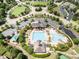 Aerial view of the community clubhouse with a swimming pool and tennis courts at 4401 Lyman Ave, Raleigh, NC 27616