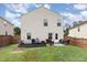This backyard features a small patio area, grassy space, and a wood fence at 4401 Lyman Ave, Raleigh, NC 27616