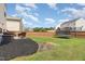 This fenced backyard includes a small patio area, grass space, and mature trees at 4401 Lyman Ave, Raleigh, NC 27616