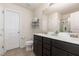 This primary bathroom features double sinks, tile flooring, and dark wood cabinetry at 4401 Lyman Ave, Raleigh, NC 27616