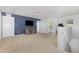 Spacious bonus room with TV, open staircase, neutral carpet and dark blue accent wall at 4401 Lyman Ave, Raleigh, NC 27616