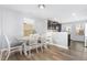 Cozy dining area with wood-look floors and a view to the kitchen at 4401 Lyman Ave, Raleigh, NC 27616