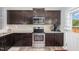 Well-equipped kitchen with dark cabinets and stainless steel appliances at 4401 Lyman Ave, Raleigh, NC 27616