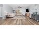 Spacious living room with wood-look floors, ceiling fan, and neutral paint at 4401 Lyman Ave, Raleigh, NC 27616