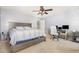 The main bedroom features a king bed, a workspace, and a ceiling fan at 4401 Lyman Ave, Raleigh, NC 27616