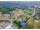 Wide aerial view showing neighborhood with multiple baseball fields, commercial, and community spaces at 470 E Wellesley Dr, Clayton, NC 27520