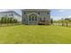 Grassy fenced backyard with a wooden deck, offering a private outdoor space at 470 E Wellesley Dr, Clayton, NC 27520