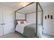 Comfortable bedroom with a stylish four-poster bed, soft bedding and light grey carpet at 470 E Wellesley Dr, Clayton, NC 27520