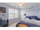Bright bedroom with white metal canopy bed, space themed bedding, and a ceiling fan at 470 E Wellesley Dr, Clayton, NC 27520