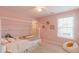 Lovely pink bedroom featuring a house frame bed and bright, natural light at 470 E Wellesley Dr, Clayton, NC 27520