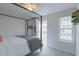 Cozy bedroom featuring a four-poster bed and a private balcony with natural light at 470 E Wellesley Dr, Clayton, NC 27520