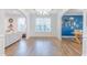 Bright dining room with hardwood floors, large window, and archways to other living spaces at 470 E Wellesley Dr, Clayton, NC 27520