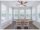 Dining room features lots of natural light with large windows, ceiling fan, and hardwood floors at 470 E Wellesley Dr, Clayton, NC 27520
