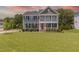Charming two-story home with a manicured lawn, double porches, and a striking red front door at 470 E Wellesley Dr, Clayton, NC 27520