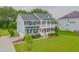 Beautiful two-story home with a gray exterior, inviting front porch, and well-maintained landscaping at 470 E Wellesley Dr, Clayton, NC 27520