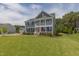 Charming two-story home with a lush green lawn and double porches, enhancing curb appeal at 470 E Wellesley Dr, Clayton, NC 27520