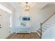 Inviting foyer with hardwood floors, white wainscoting, a staircase, and stylish decor at 470 E Wellesley Dr, Clayton, NC 27520