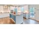 An open kitchen with a center island, stainless steel appliances, and access to backyard at 470 E Wellesley Dr, Clayton, NC 27520