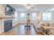 Living room with fireplace, TV, windows, hardwood floors and modern decor at 470 E Wellesley Dr, Clayton, NC 27520