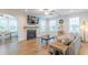 Comfortable living room with a fireplace, TV, and hardwood floors that extend to the dining area at 470 E Wellesley Dr, Clayton, NC 27520
