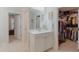 Bright main bathroom featuring a single sink vanity, and views of a walk-in closet and the hallway at 470 E Wellesley Dr, Clayton, NC 27520