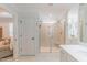 This main bathroom features a walk-in shower with a bench, a single sink vanity, and a door to the main bedroom at 470 E Wellesley Dr, Clayton, NC 27520