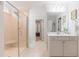 Well-lit main bathroom featuring a large walk-in shower with a bench and a vanity with storage at 470 E Wellesley Dr, Clayton, NC 27520
