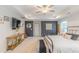 Large main bedroom with a tray ceiling, a flatscreen TV, a ceiling fan, and a seating area at 470 E Wellesley Dr, Clayton, NC 27520