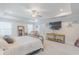 Large main bedroom featuring a tray ceiling, ceiling fan, light gray walls and carpet, and a flatscreen TV at 470 E Wellesley Dr, Clayton, NC 27520