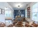 Stylish home office featuring a bold blue accent wall, custom bookshelves, and modern furnishings at 470 E Wellesley Dr, Clayton, NC 27520