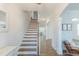 Elegant staircase with hardwood treads and white risers, leading to an upper level, next to white wainscoting at 470 E Wellesley Dr, Clayton, NC 27520