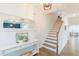 Elegant staircase with hardwood treads and white risers, complemented by stylish decor in a well-lit foyer at 470 E Wellesley Dr, Clayton, NC 27520