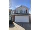 Charming two-story home with a red brick accent and a two-car garage at 4721 Mocha Ln, Raleigh, NC 27616