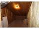 Unfinished attic with exposed insulation and rafters, lit by a single bulb at 4810 Glenmist Ct, Raleigh, NC 27612