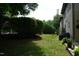 A view of the backyard that features a lush green lawn and meticulously trimmed hedges at 4810 Glenmist Ct, Raleigh, NC 27612