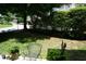Lush green backyard with neatly trimmed hedges and trees at 4810 Glenmist Ct, Raleigh, NC 27612