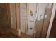 Unfinished basement wall with pipes and electrical wiring exposed at 4810 Glenmist Ct, Raleigh, NC 27612