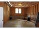 Unfinished basement with exposed wood framing, concrete floors, and two windows at 4810 Glenmist Ct, Raleigh, NC 27612